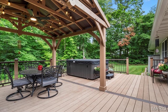 13345 Iberg Rd, Highland, IL 62249 - wooden deck with a hot tub, outdoor dining area, a gazebo, and view of scattered trees