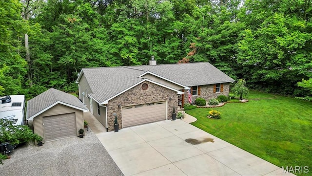 13345 Iberg Rd, Highland, IL 62249 - ranch-style home with a front lawn, concrete driveway, brick siding, a chimney, and a shingled roof