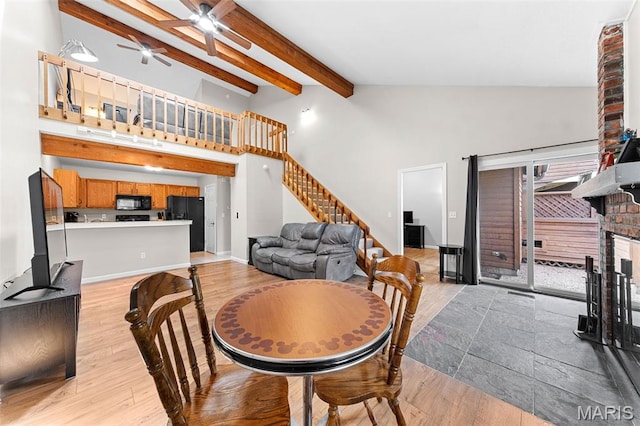 856 Hemingway Ln Unit D, Weldon Spring, MO 63304 - dining room featuring stairway, beamed ceiling, ceiling fan, a brick fireplace, and light wood-style flooring