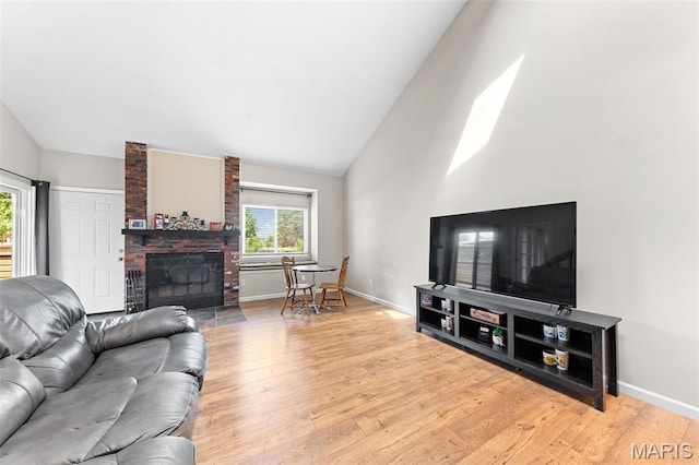 856 Hemingway Ln Unit D, Weldon Spring, MO 63304 - living area featuring light wood-type flooring, a brick fireplace, and high vaulted ceiling