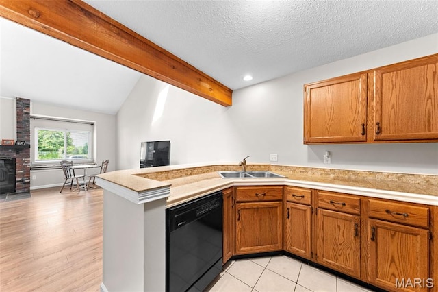 856 Hemingway Ln Unit D, Weldon Spring, MO 63304 - kitchen with black dishwasher, a peninsula, brown cabinets, light countertops, and lofted ceiling