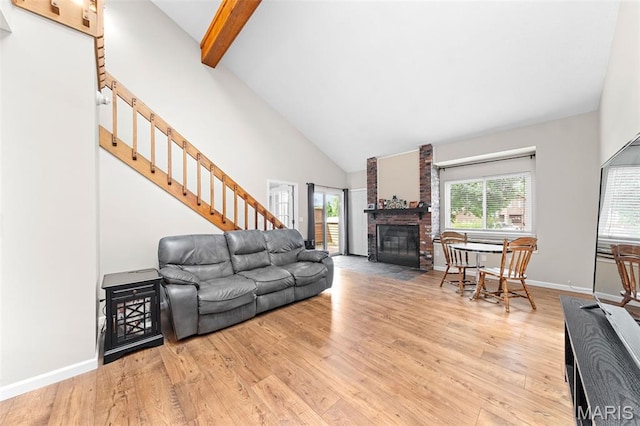 856 Hemingway Ln Unit D, Weldon Spring, MO 63304 - living room with high vaulted ceiling, wood finished floors, stairs, a fireplace, and beamed ceiling