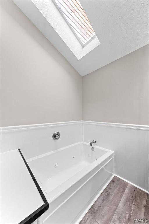 856 Hemingway Ln Unit D, Weldon Spring, MO 63304 - full bathroom with wood finished floors, a skylight, and a whirlpool tub