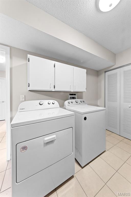 856 Hemingway Ln Unit D, Weldon Spring, MO 63304 - laundry area featuring cabinet space, washer and dryer, a textured ceiling, and light tile patterned flooring