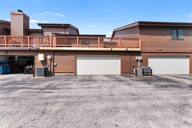 856 Hemingway Ln Unit D, Weldon Spring, MO 63304 - back of house featuring asphalt driveway and a deck
