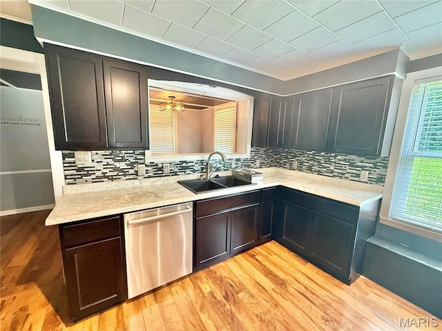 904 Vernon St, Farmington, MO 63640 - kitchen with stainless steel dishwasher, crown molding, decorative backsplash, light countertops, and light wood-style floors