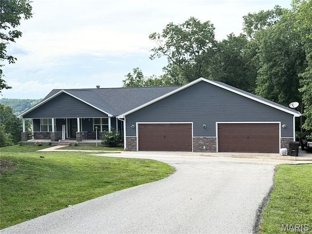 22115 Royce Ln, Waynesville, MO 65583 - view of front of property featuring stone siding, a porch, driveway, a front yard, and an attached garage