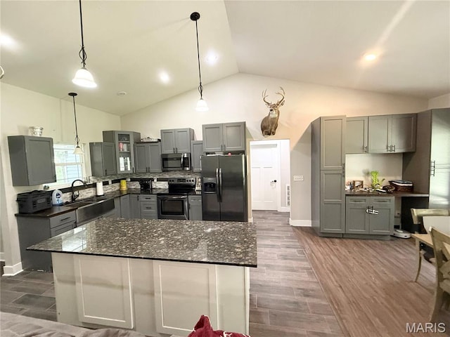22115 Royce Ln, Waynesville, MO 65583 - kitchen featuring appliances with stainless steel finishes, gray cabinets, dark wood finished floors, hanging light fixtures, and high vaulted ceiling