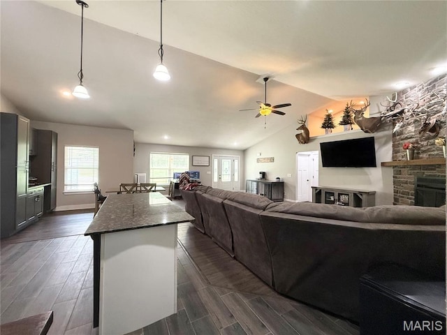 22115 Royce Ln, Waynesville, MO 65583 - living area featuring vaulted ceiling, ceiling fan, a fireplace, and dark wood finished floors