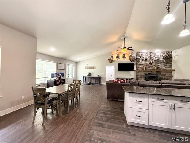 22115 Royce Ln, Waynesville, MO 65583 - dining area featuring a fireplace, ceiling fan, dark wood-style floors, and lofted ceiling