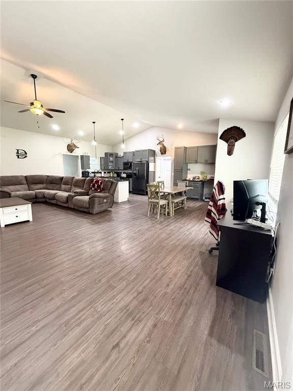 22115 Royce Ln, Waynesville, MO 65583 - living area with lofted ceiling, dark wood finished floors, and ceiling fan