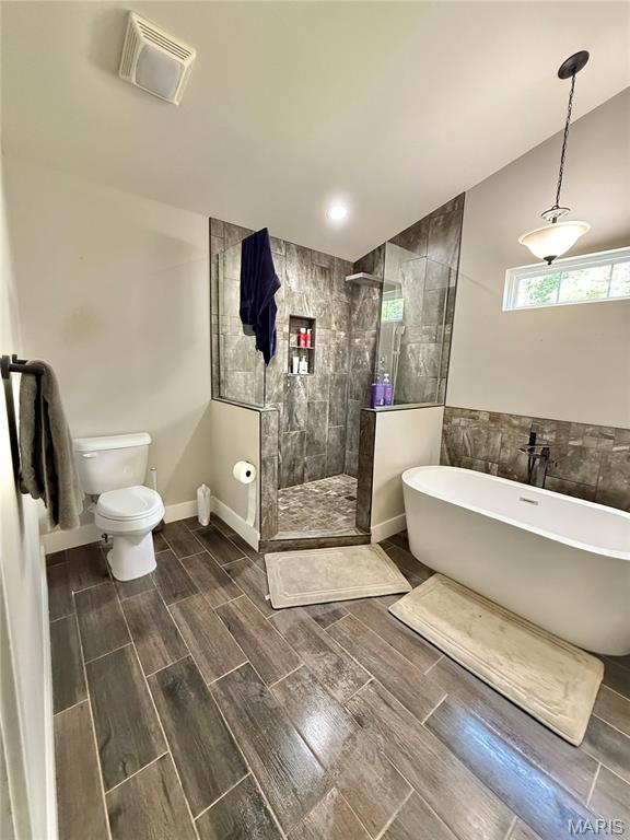 22115 Royce Ln, Waynesville, MO 65583 - bathroom featuring a soaking tub, wood finish floors, walk in shower, and tile walls