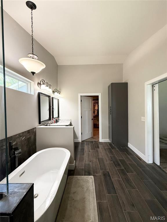 22115 Royce Ln, Waynesville, MO 65583 - full bathroom featuring a freestanding tub, vanity, and wood finished floors
