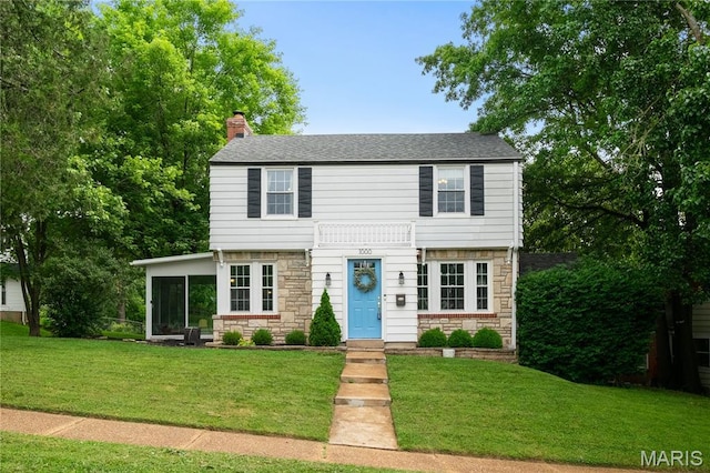 1000 Diversey Dr, Crestwood, MO 63126 - colonial home featuring stone siding, a chimney, a sunroom, and a front lawn