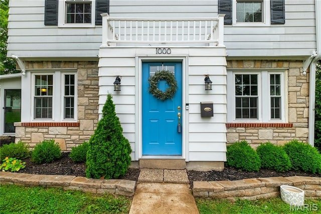 1000 Diversey Dr, Crestwood, MO 63126 - view of exterior entry featuring stone siding and a balcony