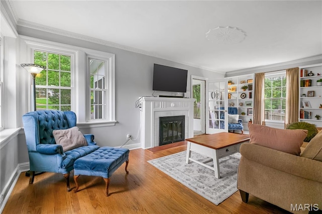 1000 Diversey Dr, Crestwood, MO 63126 - living area with crown molding, plenty of natural light, a glass covered fireplace, and wood finished floors