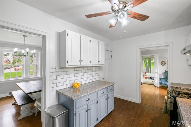 1000 Diversey Dr, Crestwood, MO 63126 - kitchen with gas stove, ceiling fan, dark wood-type flooring, and decorative backsplash