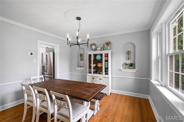 1000 Diversey Dr, Crestwood, MO 63126 - dining space featuring a chandelier, crown molding, and light wood finished floors