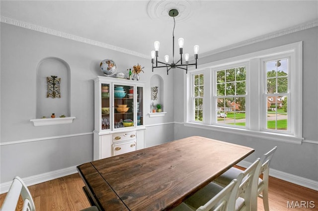 1000 Diversey Dr, Crestwood, MO 63126 - dining area with a chandelier, wood finished floors, and crown molding