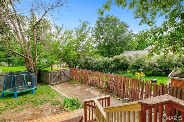 1000 Diversey Dr, Crestwood, MO 63126 - view of yard with a gate, a trampoline, and view of wooded area
