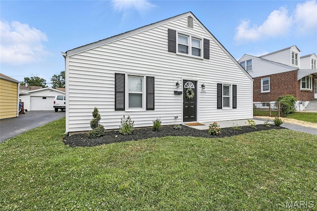 9441 Ridge Ave, Overland, MO 63114 - bungalow-style home featuring a front yard, a garage, and an outdoor structure