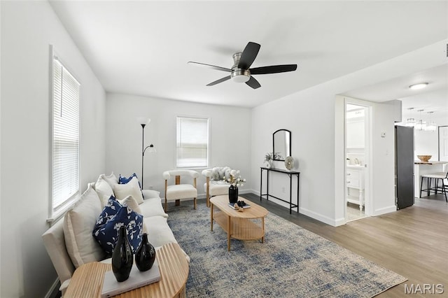 9441 Ridge Ave, Overland, MO 63114 - living area featuring wood finished floors, ceiling fan, and a chandelier