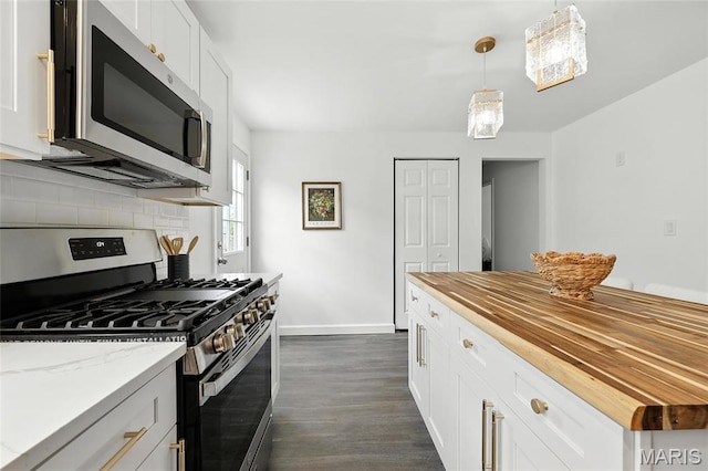 9441 Ridge Ave, Overland, MO 63114 - kitchen with appliances with stainless steel finishes, wooden counters, dark wood-style flooring, tasteful backsplash, and white cabinets