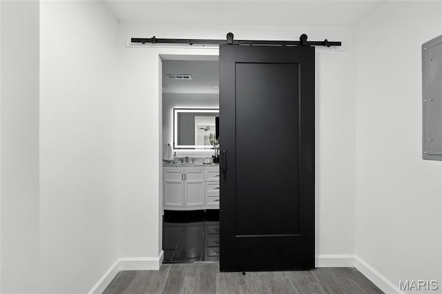 9441 Ridge Ave, Overland, MO 63114 - corridor featuring wood finished floors and a barn door