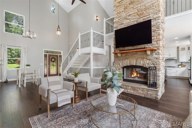 3516 Hawthorne Ridge Dr, Eureka, MO 63025 - living area featuring high vaulted ceiling, dark wood-style flooring, a fireplace, ceiling fan, and french doors