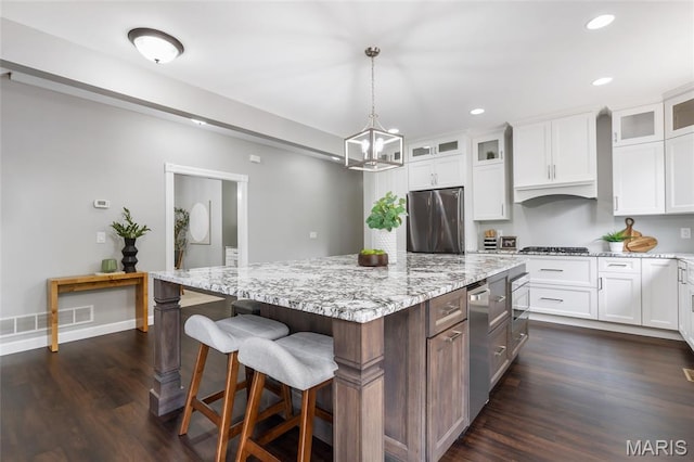 3516 Hawthorne Ridge Dr, Eureka, MO 63025 - kitchen with stainless steel appliances, white cabinets, recessed lighting, dark wood-style floors, and light stone counters