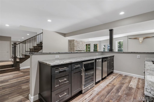 3516 Hawthorne Ridge Dr, Eureka, MO 63025 - kitchen featuring beverage cooler, light wood-style flooring, light stone countertops, and recessed lighting