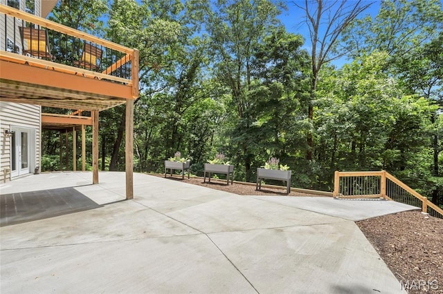 3516 Hawthorne Ridge Dr, Eureka, MO 63025 - view of patio featuring a deck, concrete driveway, and view of scattered trees