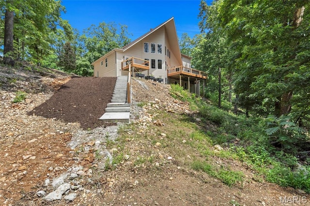 3516 Hawthorne Ridge Dr, Eureka, MO 63025 - view of side of home with a deck, dirt driveway, and stairs
