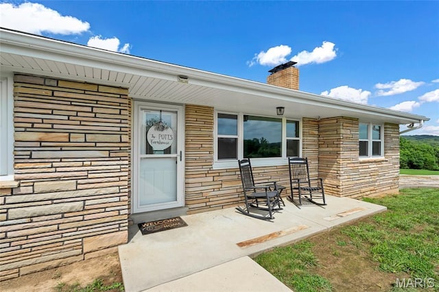 5701 State Road P, De Soto, MO 63020 - doorway to property featuring stone siding and a chimney