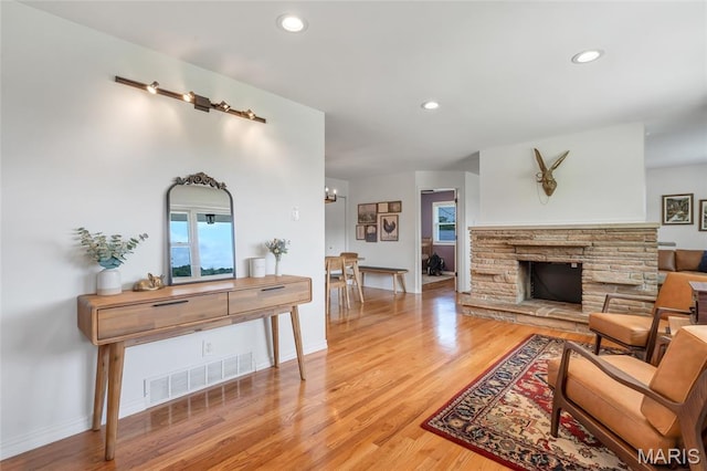 5701 State Road P, De Soto, MO 63020 - living room with light wood-style flooring, recessed lighting, and a fireplace