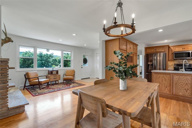 5701 State Road P, De Soto, MO 63020 - dining space featuring a chandelier, light wood-type flooring, and recessed lighting