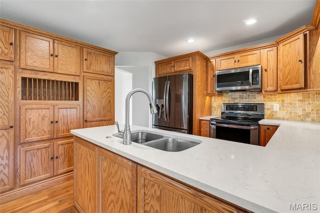 5701 State Road P, De Soto, MO 63020 - kitchen with appliances with stainless steel finishes, backsplash, light wood-style floors, light stone countertops, and recessed lighting