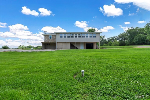 5701 State Road P, De Soto, MO 63020 - back of house featuring a yard, stone siding, and a deck
