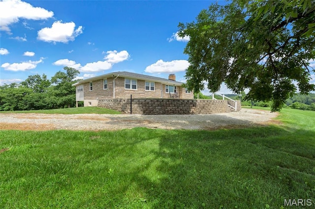 5701 State Road P, De Soto, MO 63020 - view of property exterior with a chimney, a yard, and stone siding