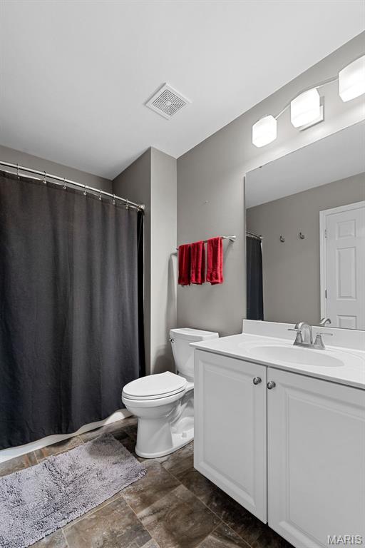 107 Piety Dr, Lake St Louis, MO 63367 - bathroom featuring vanity, stone finish flooring, and a shower with shower curtain