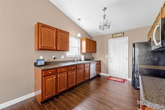 107 Piety Dr, Lake St Louis, MO 63367 - kitchen with appliances with stainless steel finishes, a chandelier, vaulted ceiling, dark countertops, and dark wood-type flooring