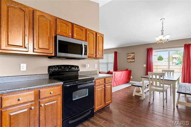 107 Piety Dr, Lake St Louis, MO 63367 - kitchen featuring black range with electric cooktop, stainless steel microwave, a chandelier, and plenty of natural light