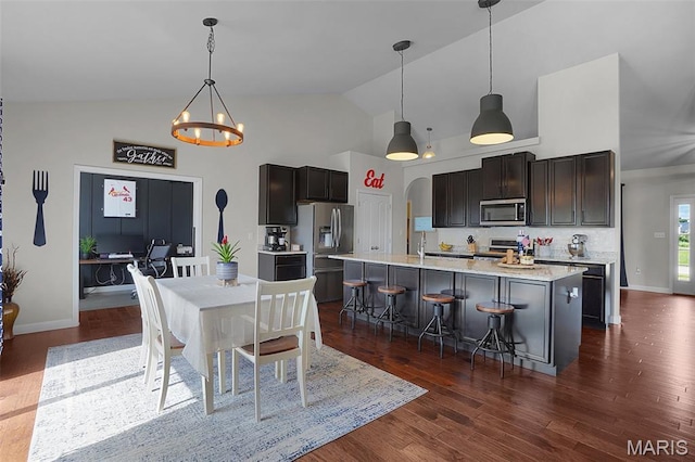 234 Lonepine Dr, Wentzville, MO 63385 - dining room with high vaulted ceiling, a chandelier, and dark wood-style floors