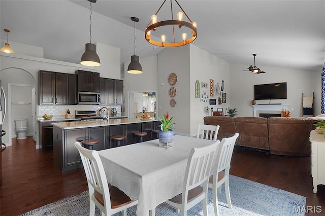 234 Lonepine Dr, Wentzville, MO 63385 - dining room with dark wood-type flooring, high vaulted ceiling, ceiling fan, and a chandelier