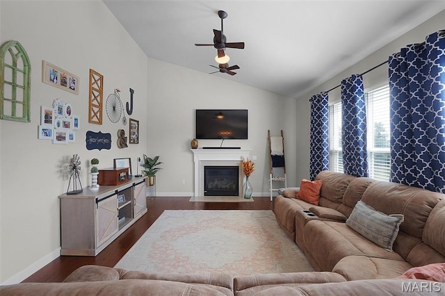234 Lonepine Dr, Wentzville, MO 63385 - living room featuring lofted ceiling, ceiling fan, dark wood-style floors, and a fireplace with flush hearth
