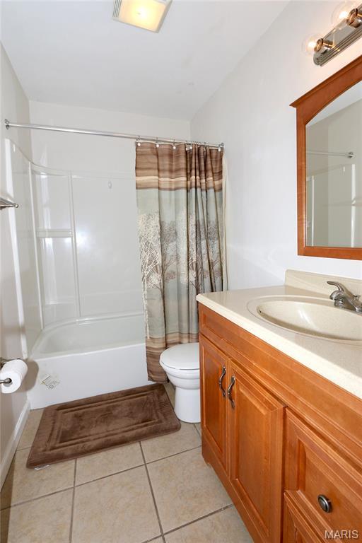 10640 Carroll Wood Way, Saint Louis, MO 63128 - full bathroom featuring vanity, shower / tub combo, and tile patterned flooring