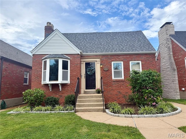 6035 Lansdowne Ave, Saint Louis, MO 63109 - view of front of home featuring a chimney, brick siding, a front yard, and roof with shingles