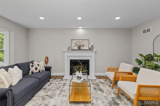 145 Aspencade Cir, Saint Peters, MO 63376 - living room featuring recessed lighting, wood finished floors, and a fireplace with flush hearth