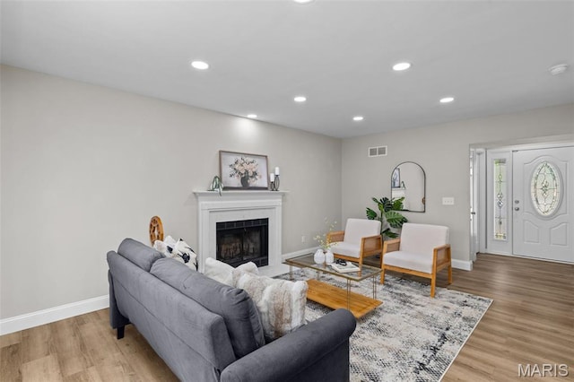 145 Aspencade Cir, Saint Peters, MO 63376 - living area with recessed lighting, light wood-style flooring, and a fireplace with flush hearth
