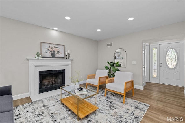 145 Aspencade Cir, Saint Peters, MO 63376 - living room with wood finished floors, a fireplace with flush hearth, and recessed lighting
